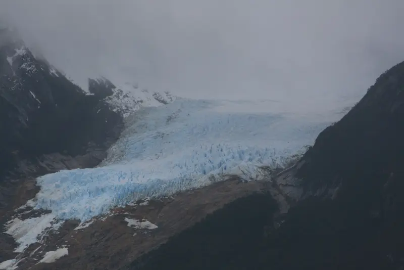 Tongue of the Balmaceda Glacier flowing between mountains down to the fjord