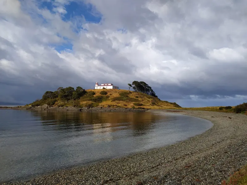 Forested peninsula and the San Isidro Lighthouse on the Strait of Magellan coast