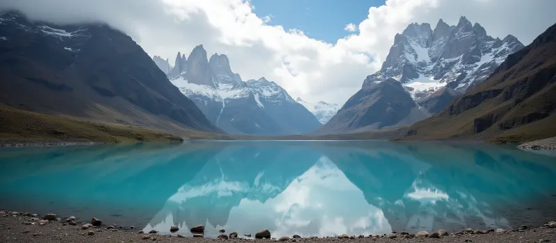 Turquoise lake in front of the snow-capped Paine massif